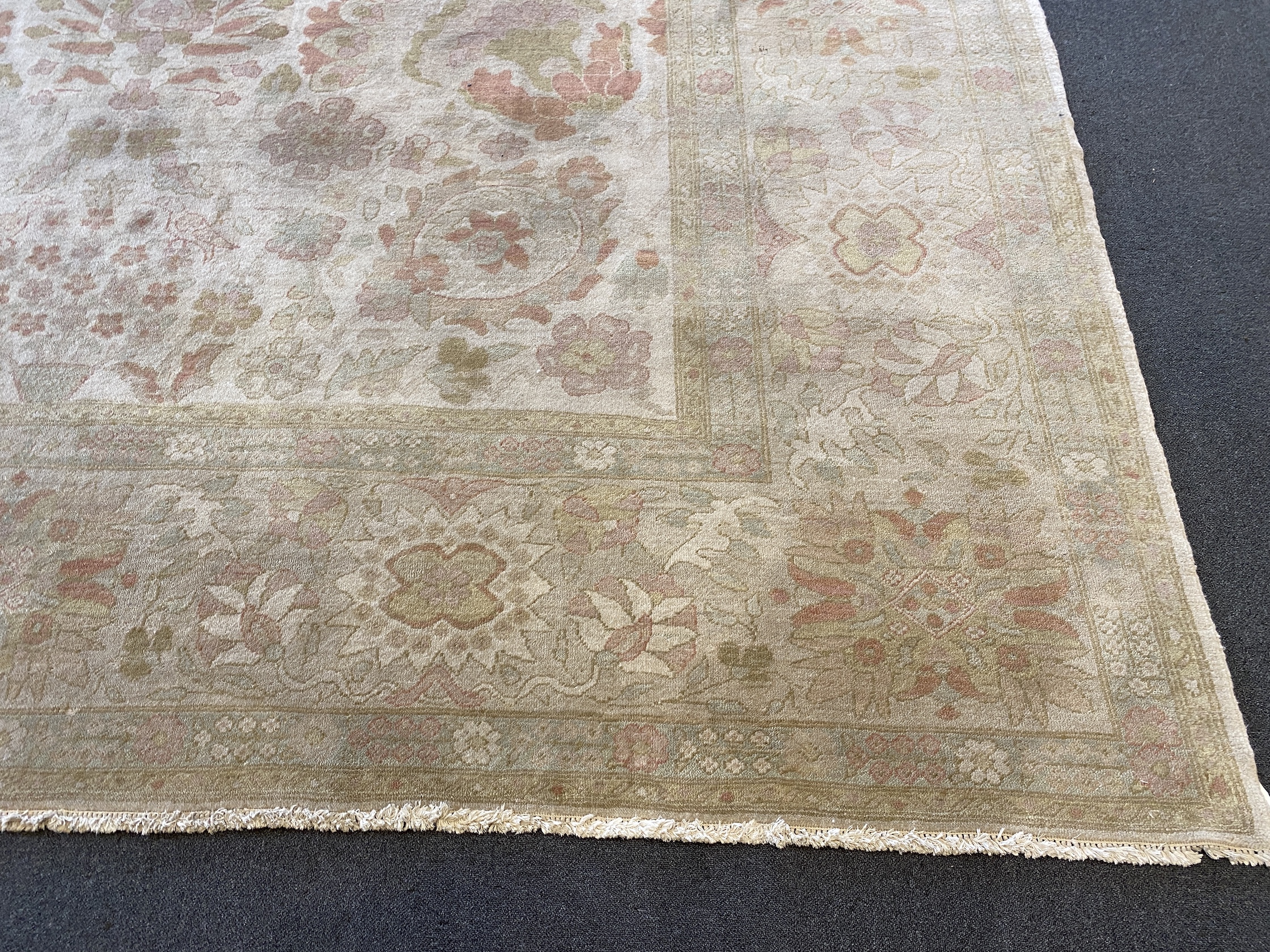 A large Indian ivory ground carpet, 445 x 372cm